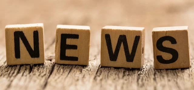 vier kleine Holzwürfel mit Buchstaben darauf bilden das Wort NEWS